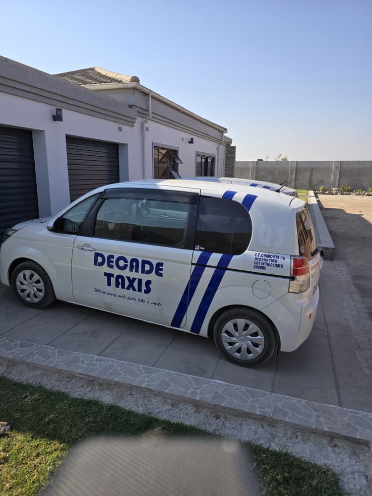 Decade Taxis fleet — vehicle side view with blue stripe livery