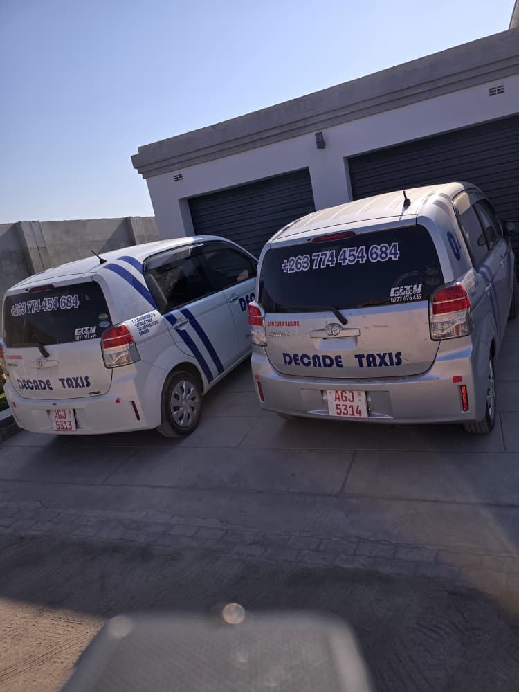 Decade Taxis — two fleet vehicles, rear view